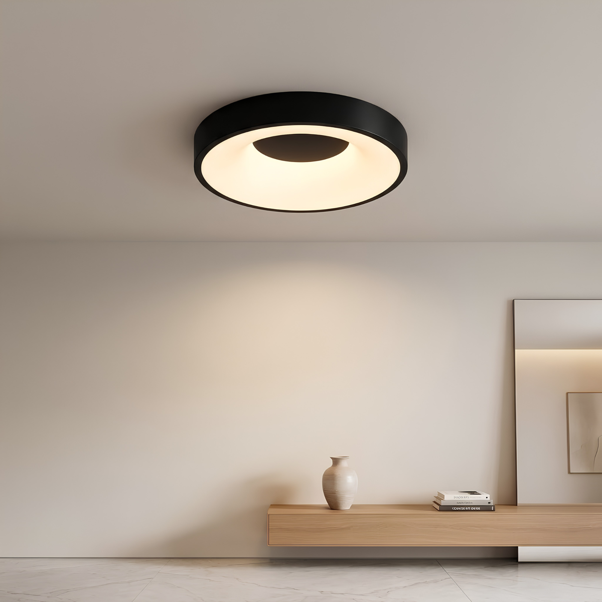 Matte black LED flush mount drum ceiling light glowing softly above in a space.