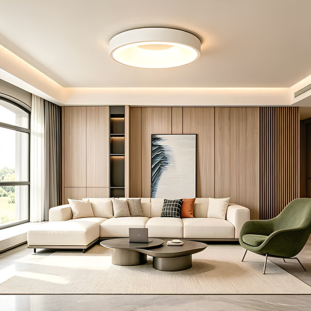 Matte white LED flush mount drum ceiling light illuminating a minimalist living room with a timber feature wall and cream sofa.