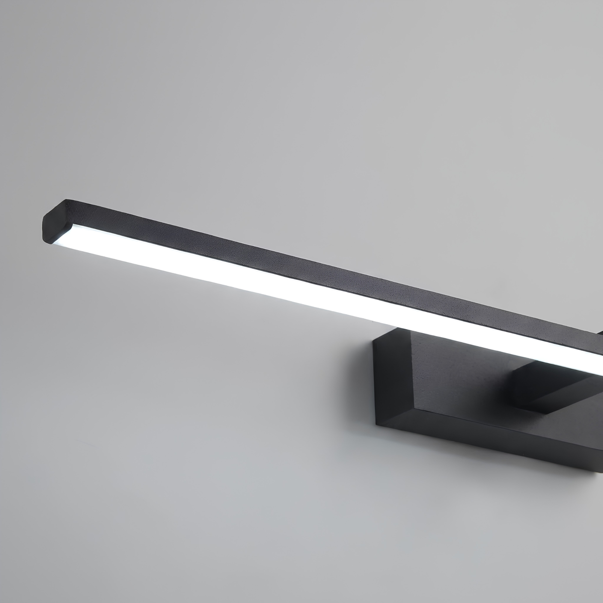 Close-up macro shot of the matte black aluminium edge and frosted diffuser lens of an LED vanity bar light.