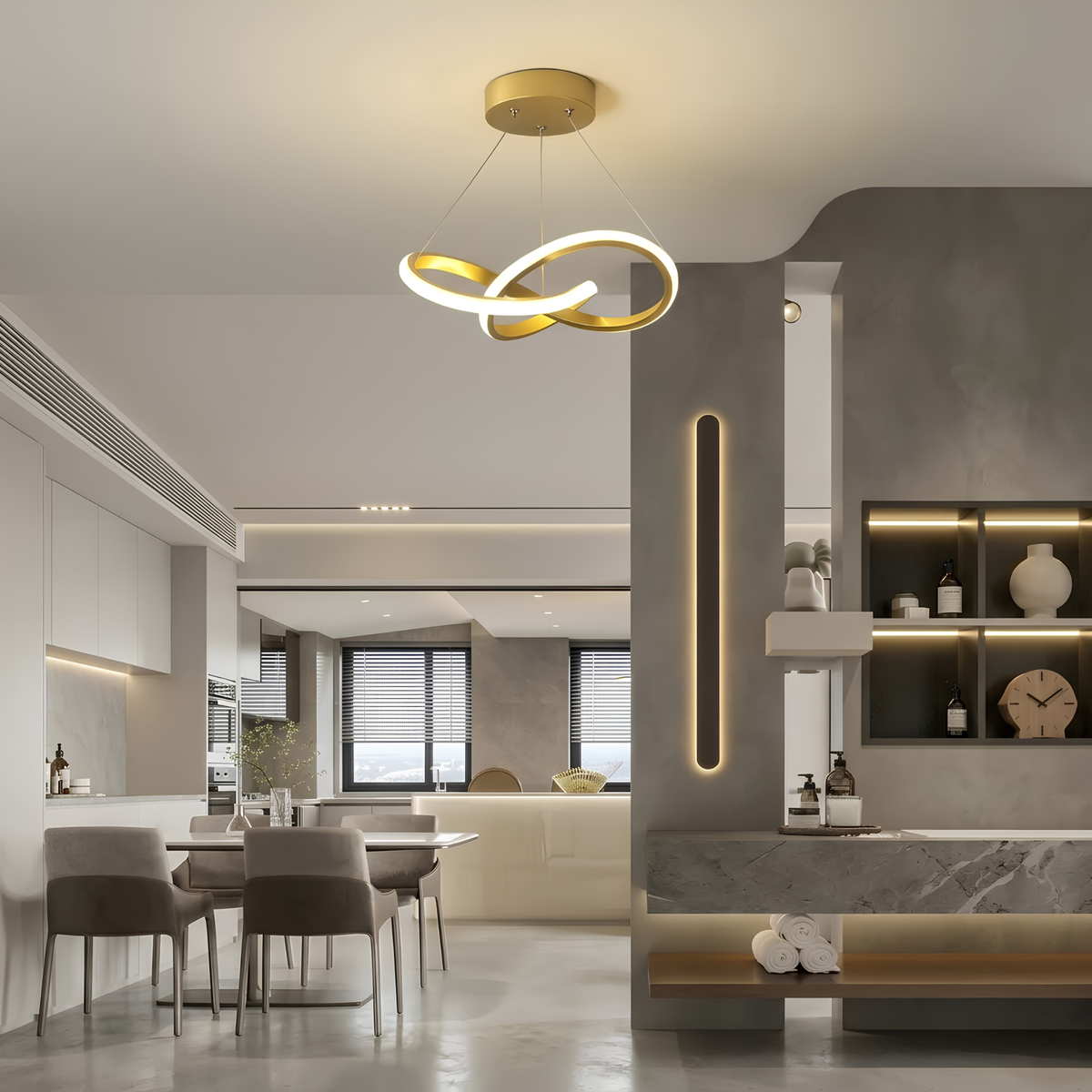 Gold sculptural interlocking-ring LED pendant light illuminated in a hallway leading to an open-plan dining area and bathroom vanity.